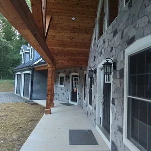 Cedar tongue-and-groove porch ceiling and stone veneer facade in Elverson, PA