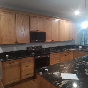 Kitchen with black appliances and granite countertops in Elverson, PA
