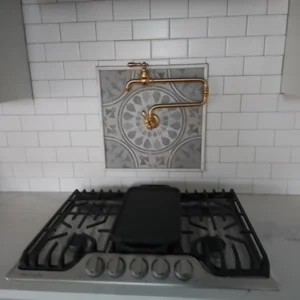 Custom kitchen tile backsplash and a gas stove