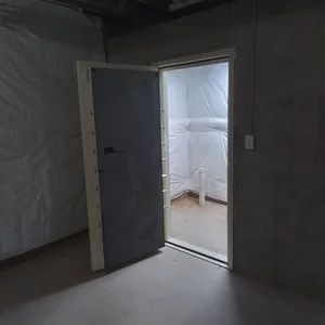 Secure firearms storage vault room with Homeland Security-rated vault door