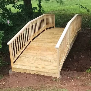 Wood footbridge spanning a backyard creek in Phoenixville, PA