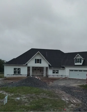 Roofing materials and supplies staged on site for an Amish roof installation