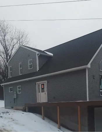 Experienced Amish roofer meticulously installing new shingles during roof replacement