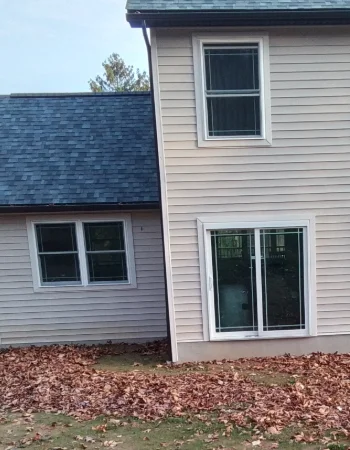 Professional Amish Siding Services installing durable vinyl siding on a residential home