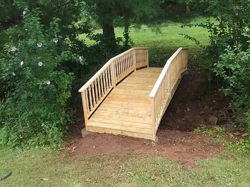 Wood footbridge over a backyard creek in Phoenixville, PA