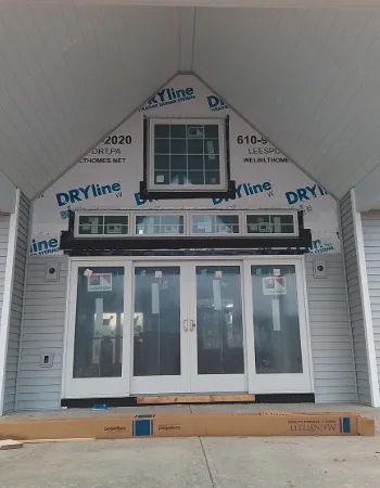 Sunny Ridge Construction team installing new siding on a residential home in Ardmore, PA