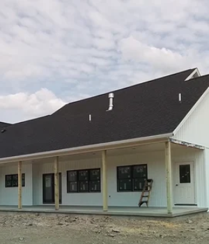 Completed home exterior with asphalt shingle roofing and white siding in Compass, PA