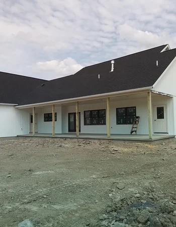 Completed home exterior with asphalt shingle roofing and white siding in Compass, PA