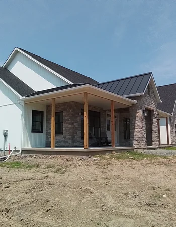 Newly constructed home with standing seam metal roofing and stone siding in Downingtown, PA