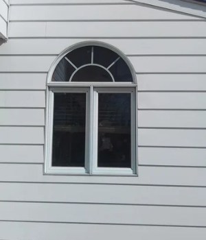 Full exterior home renovation featuring new siding and a window installation in Frazer, PA